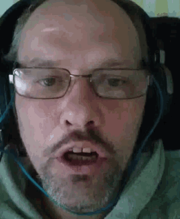 a man wearing glasses and headphones is making a funny face .