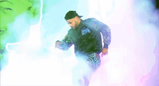 a man is standing on a stage wearing a colorful jacket with graffiti on it .