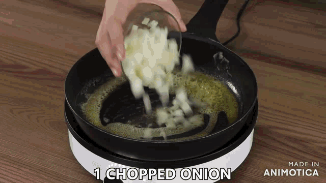 chopped onion being poured into a frying pan