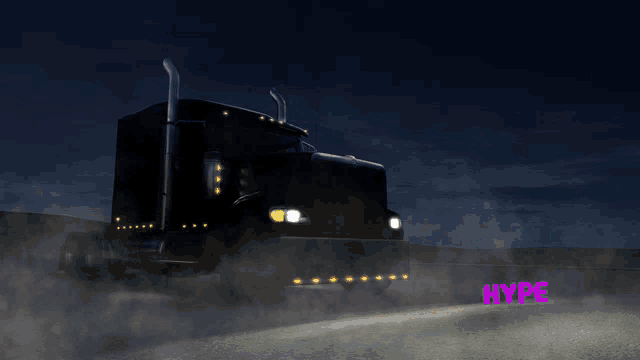 a black semi truck is driving down a highway at night