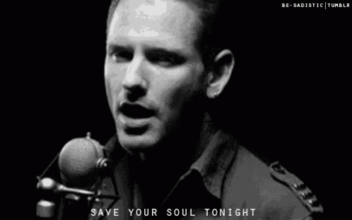 a man singing into a microphone with the words save your soul tonight