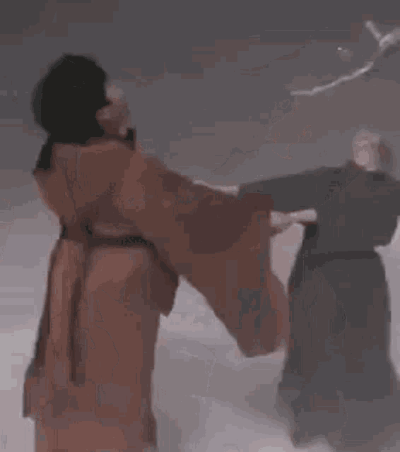 a couple of people standing next to each other in a snowy field .