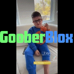 a young boy wearing glasses is sitting on a couch with the words goober blox written on the bottom .