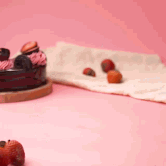 a slice of cake with strawberry frosting and oreos on top