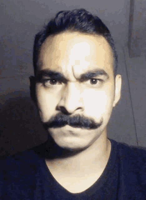 a man with a mustache is making a silly face