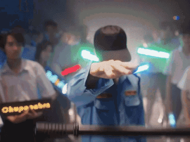 a man in a blue uniform holds a sign that says escape babes