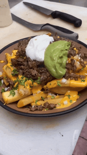 a close up of a plate of food with guacamole and sour cream