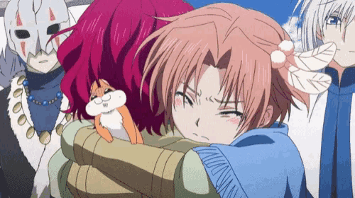 a girl with red hair is hugging another girl with a cat on her chest