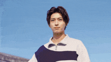 a young man wearing a blue and white striped shirt