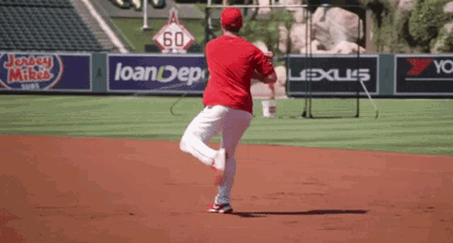 a baseball player is running on a field with a sign that says 60 on it