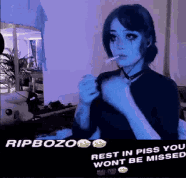 a girl is smoking a cigarette in a room with a purple light behind her .