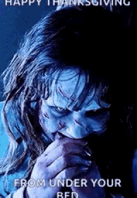 a woman with a scary face is eating a piece of bread .