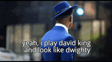 a man wearing a blue suit and a blue hat says yeah i play david king and look like dwighty