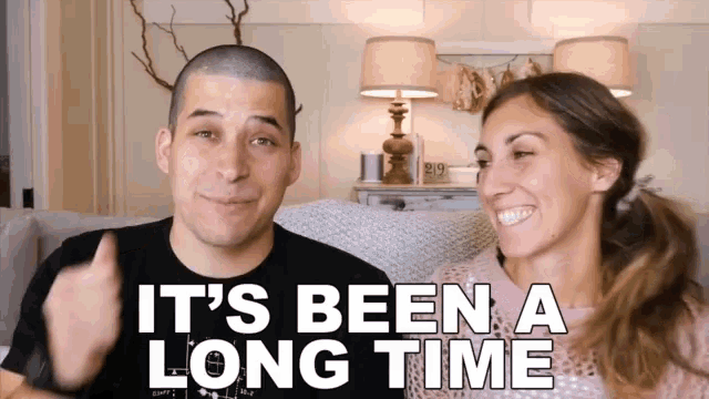 a man and a woman sitting on a couch with the words it 's been a long time