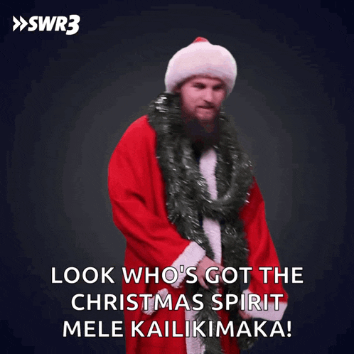 a man in a santa suit says " look who 's got the christmas spirit mele kailikimaka "