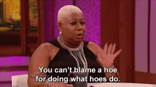 a woman is sitting at a table saying you can 't blame a hoe for doing what hoes do ..