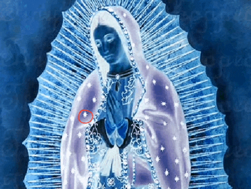 a blue and white painting of the virgin mary with a red circle around her chest