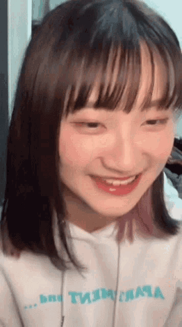 a close up of a girl wearing a hoodie that says ' t.i.m. ' on it