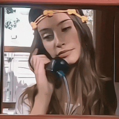 a woman talking on a phone with a yellow headband on her head
