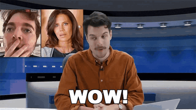 a man with a mustache is sitting at a desk with the word wow written on it