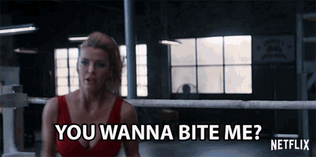 a woman is in a boxing ring and says you wanna bite me