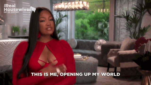 a woman says " this is me opening up my world " in front of a living room
