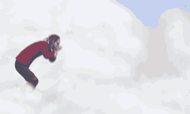 a person in a red jacket and yellow boots is flying through the air