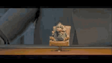 a fox and a rabbit are standing next to each other on a table in a room .