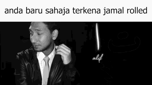 a black and white photo of a person 's hand with the words anda baru sajaa terkena jamal rolled below it