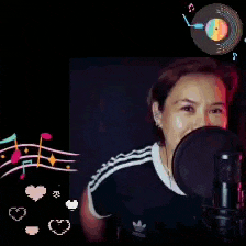 a woman singing into a microphone with the words happ tas written above her