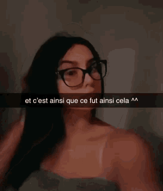a woman wearing glasses has a snap that says et c ' est ainsi que ce fut ainsi cela
