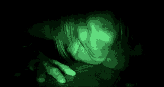 a person 's face is glowing in the dark