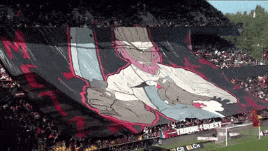 a stadium full of people with a banner that says tribune quest