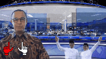 a man wearing glasses stands in front of a screen with a red hand pointing at him