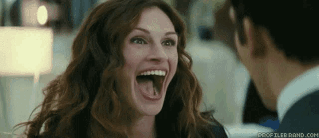 a woman is laughing with her tongue hanging out and the website profilebrand.com is visible in the corner