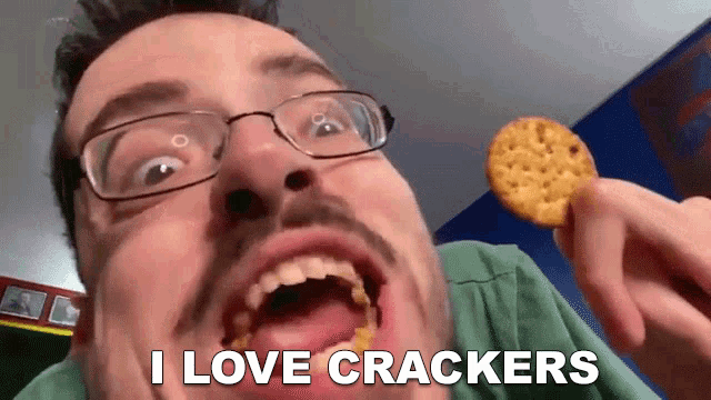 a man with glasses is eating a cracker with the words i love crackers above him
