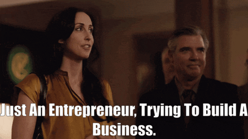 a man and a woman are standing next to each other with the words just an entrepreneur trying to build a business