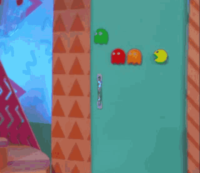 a woman is standing in front of a door that has pac man stickers on it