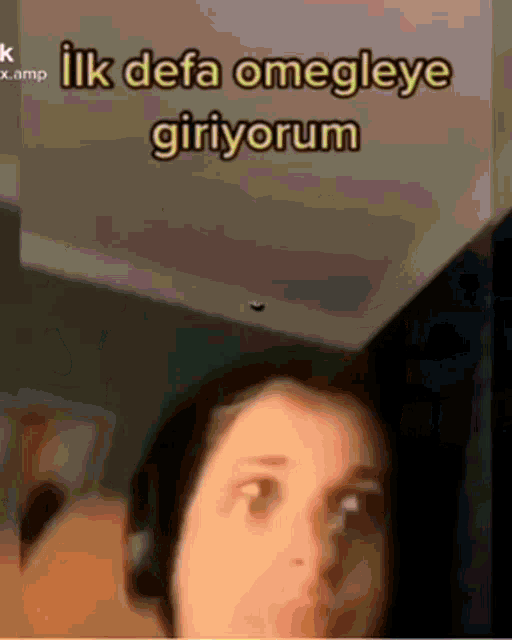 a woman wearing headphones looks at the camera with the words ilk defa omegleye giriyorum above her head