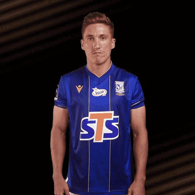 a soccer player wearing a blue shirt that says sts on it