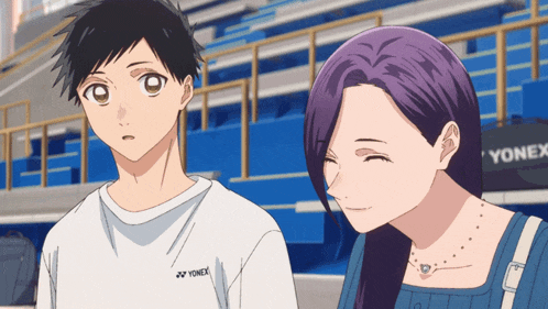 a man and a woman are standing next to each other and the man is wearing a yonex shirt
