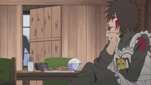 a person in a maid outfit sits in front of a table with a bowl of rice on it