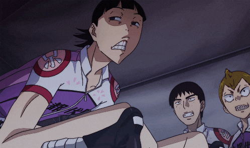 a man in a purple shirt with a red stripe on the shoulder looks angry
