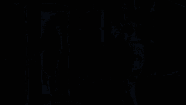 a man in a white jacket is standing next to a man in a black jacket