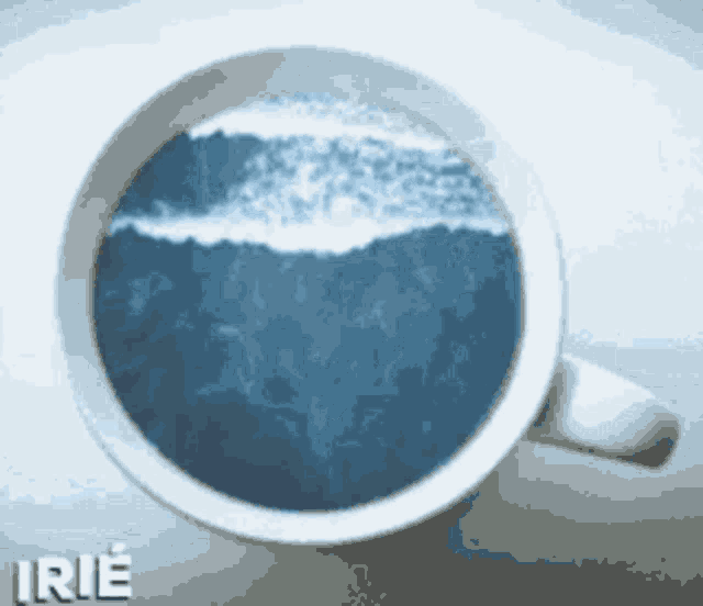 a coffee cup with a picture of a wave in it