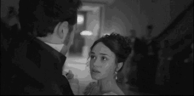 a man and a woman are dancing together in a black and white photo