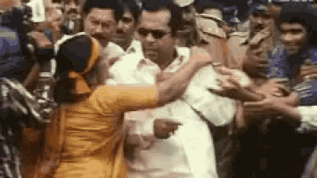 a woman is standing next to a man in a crowd of people .