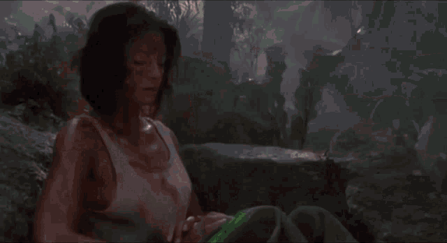 a woman 's hand is touching a green liquid .