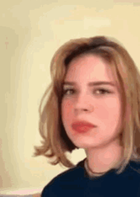 a close up of a woman 's face with short blonde hair .