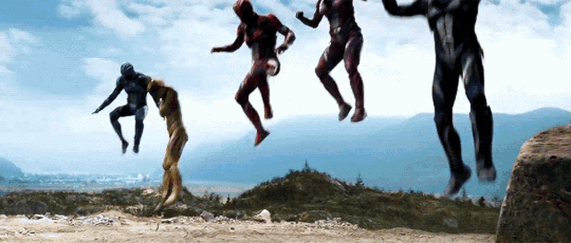 a group of superheros jumping in the air